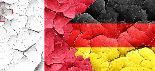 Malta flag with Germany flag on a grunge cracked wall
