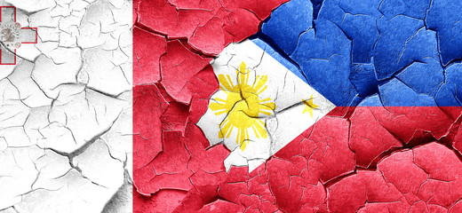 Malta flag with Philippines flag on a grunge cracked wall