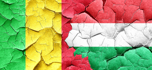 Mali flag with Hungary flag on a grunge cracked wall
