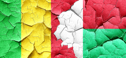 Mali flag with Madagascar flag on a grunge cracked wall