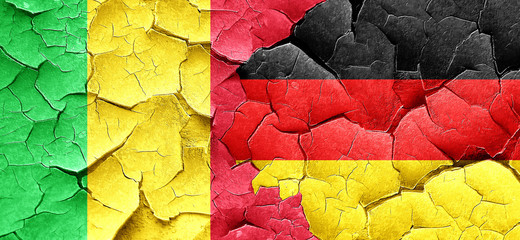 Mali flag with Germany flag on a grunge cracked wall