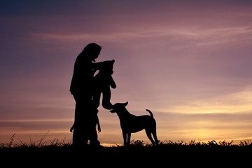 Silhouette women and dog with at sky sunset