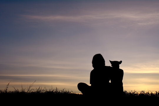 Silhouette women and dog with at sky sunset