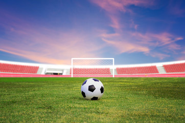 Soccer ball on the field with blue sky background