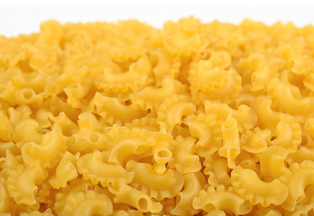 Heap of uncooked italian pasta on a white