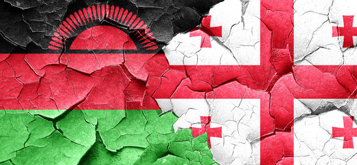 Malawi flag with Georgia flag on a grunge cracked wall
