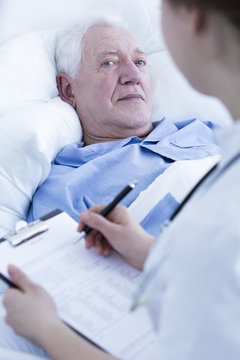 Nurse Interviewing Elderly Patient