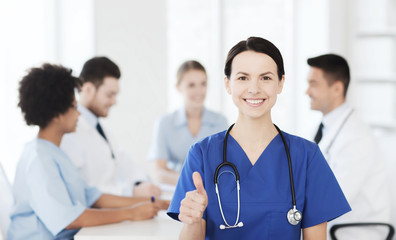 Fototapeta premium happy doctor over group of medics at hospital