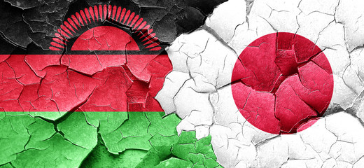 Malawi flag with Japan flag on a grunge cracked wall