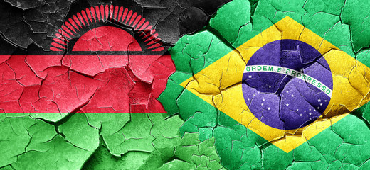 Malawi flag with Brazil flag on a grunge cracked wall