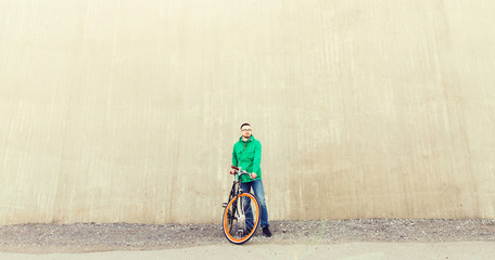 happy young hipster man with fixed gear bike