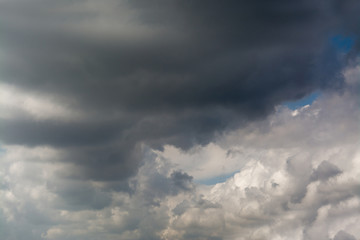White fluffy storm clouds in blue sky