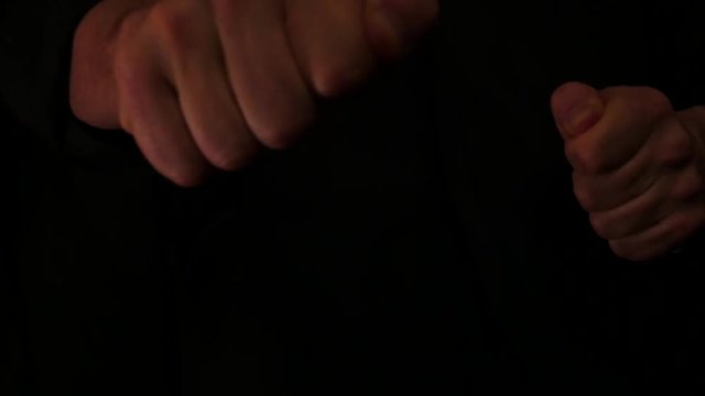 isolated fists making approaching  hits on black background