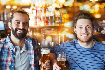 happy male friends drinking beer at bar or pub