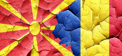 Macedonia flag with Romania flag on a grunge cracked wall