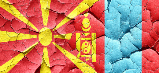 Macedonia flag with Mongolia flag on a grunge cracked wall