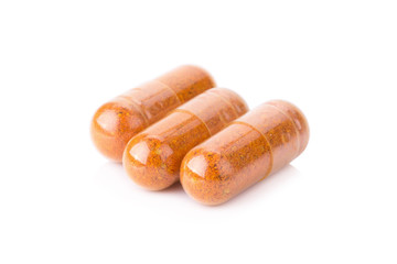 Turmeric powder inside a capsule isolated on white