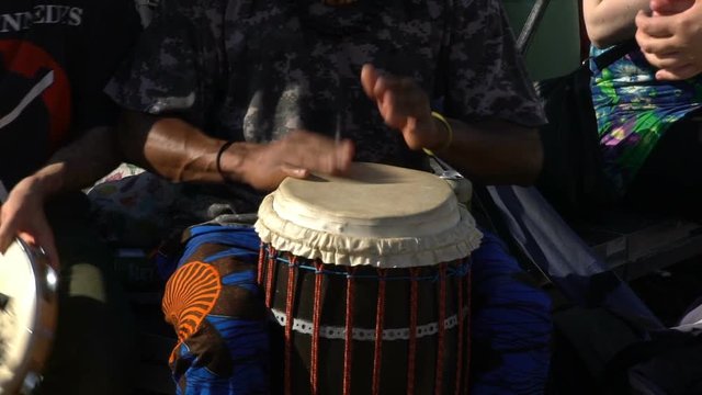 Young people sing and play drums in a City Park. Slow Motion.