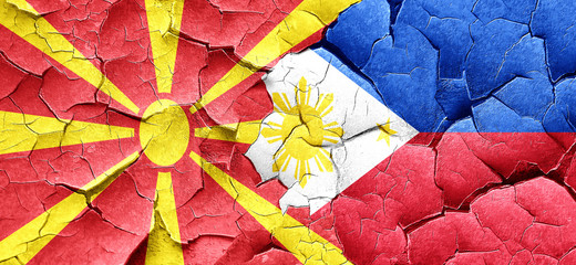 Macedonia flag with Philippines flag on a grunge cracked wall