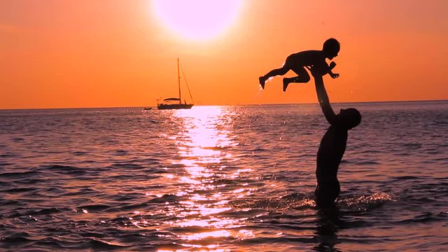 Father with son playing in the sea