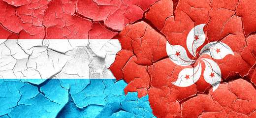 Luxembourg flag with Hong Kong flag on a grunge cracked wall