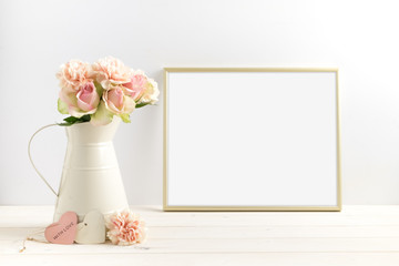 Mockup styled stock photograph of cream jug of flowers next to a Gold frame. You can place your business promotion, blog title, quote, headline or image in the frame.