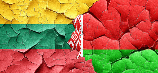 Lithuania flag with Belarus flag on a grunge cracked wall