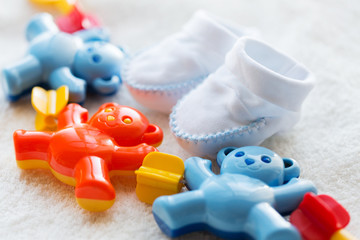 Fototapeta premium close up of baby rattle and bootees for newborn