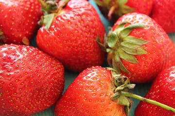 Strawberries on wooden blue desk.
