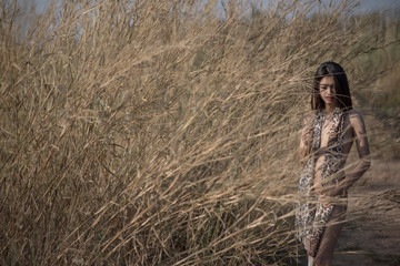Sexy Asian Girl in bikini in the meadow and grass frond