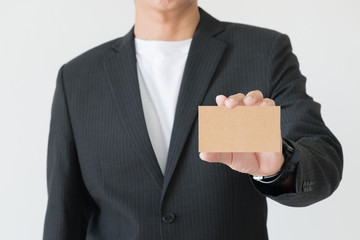 man in business suit holding white blank business card. Business