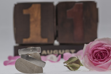 wedding rings with a rose on white background