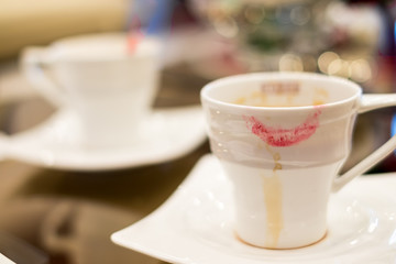 Soft focus of woman lipstick mark on cup of coffee