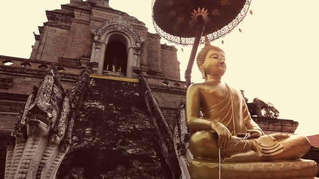 Buddha and Chedi in Wat Chiang Man, Chiang Mai, Thailand. Zoom in. Instagram filter style.