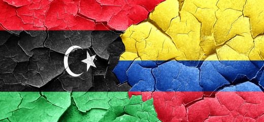 Libya flag with Colombia flag on a grunge cracked wall