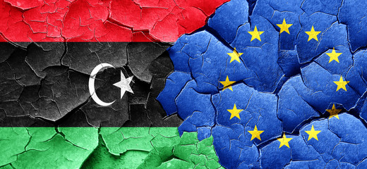 Libya flag with european union flag on a grunge cracked wall
