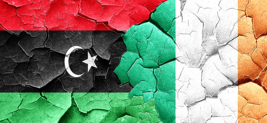 Libya flag with Ireland flag on a grunge cracked wall