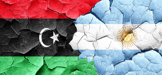Libya flag with Argentine flag on a grunge cracked wall