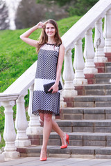 Portrait of beautiful girl in dress outdoors in the Park