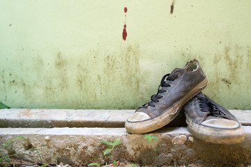 Old sneakers placed on the sand