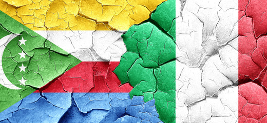 Comoros flag with Italy flag on a grunge cracked wall