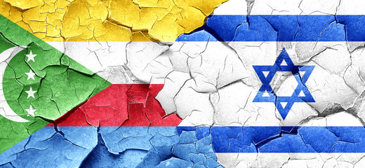 Comoros flag with Israel flag on a grunge cracked wall