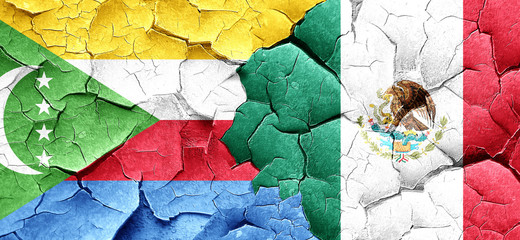 Comoros flag with Mexico flag on a grunge cracked wall