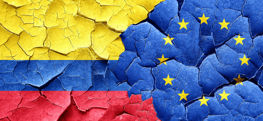 Colombia flag with european union flag on a grunge cracked wall