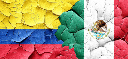 Colombia flag with Mexico flag on a grunge cracked wall