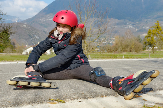 teenage skater grimacing in pain after taking fall