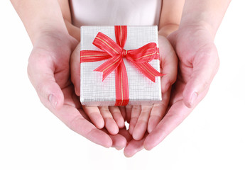 Hands holding beautiful gift box, adult and child giving gift, Christmas holidays and greeting season concept 