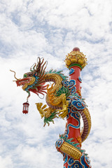 Fototapeta na wymiar Dragon sculpture with blue sky, Dragon in Chinese temple Beautiful Dragon, Dragon wrapped around a pole