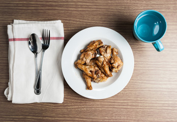 plate of chicken wings spicy on wooden table