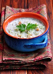 Cold summer soup from yogurt with cucumber, walnuts, raisins and mint